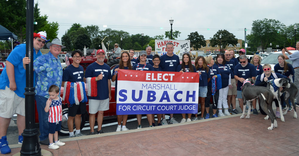 Marshall Subach and supporters at Harvest Fest with banner